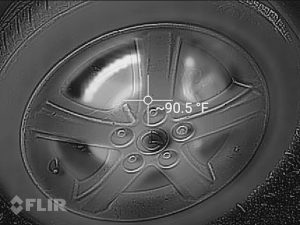 Black and white infrared image of a car wheel.